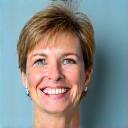 Headshot of Sarah L., a smiling woman in her late 40s, looking optimistic and financially secure.